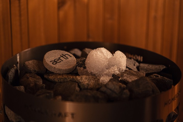Sauna heater stones with a branded rock and ice on top.